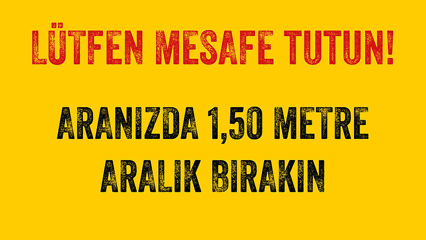 Corona Abstandsschild auf gelben Untergrund in türkischer Sprache